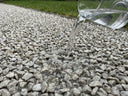 Water draining straight through a Pro-Hold bonded gravel path — fully permeable, no puddles